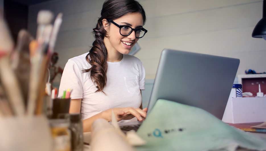 woman with glasses on laptop