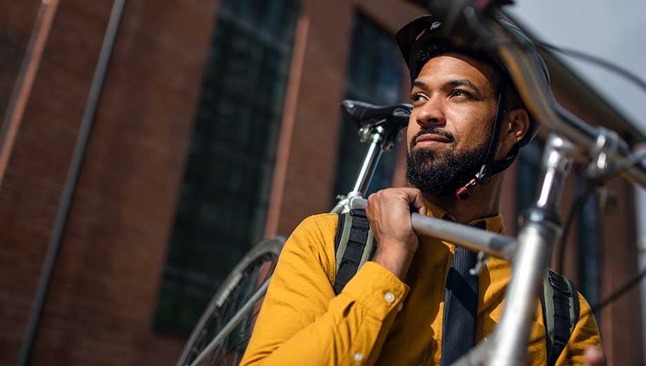 cyclist holding bicycle