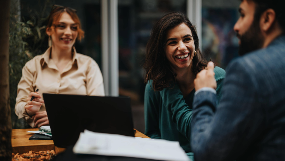Happy smiling young woman using laptop