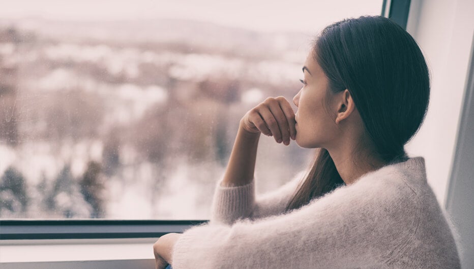 woman staring out window