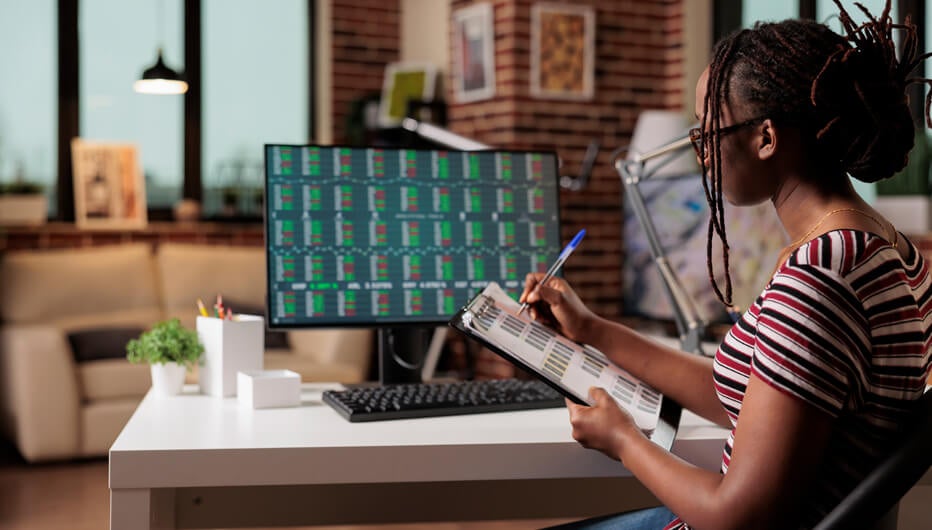 woman taking notes from screen