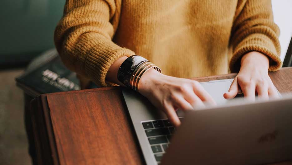 close up of person working on laptop