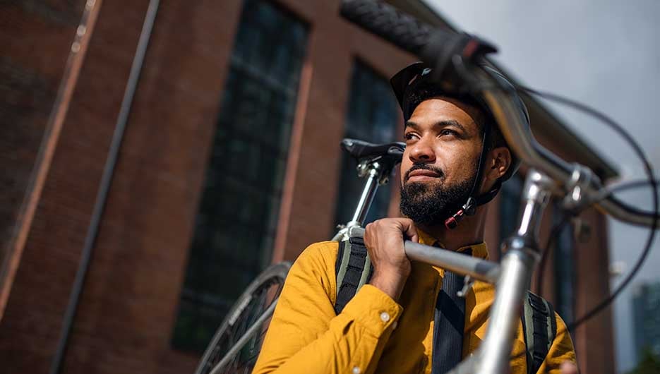 cyclist holding bicycle