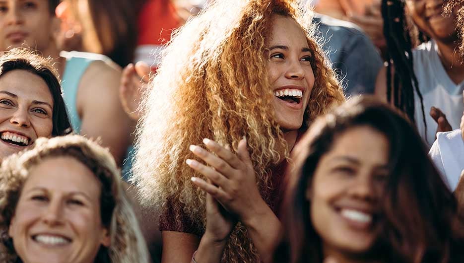 happy woman cheering at sports game